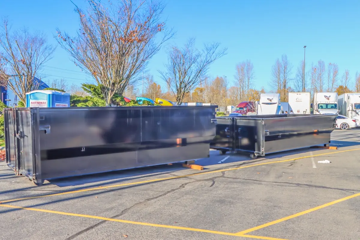 Professional dumpster rental service with roll-off container on residential driveway in Londonderry